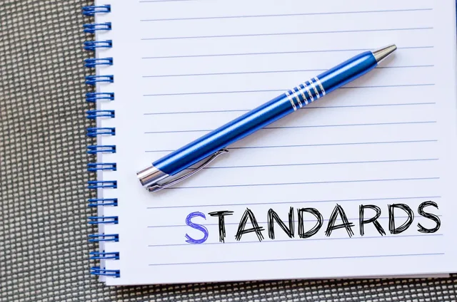 Pen and notebook labeled standards