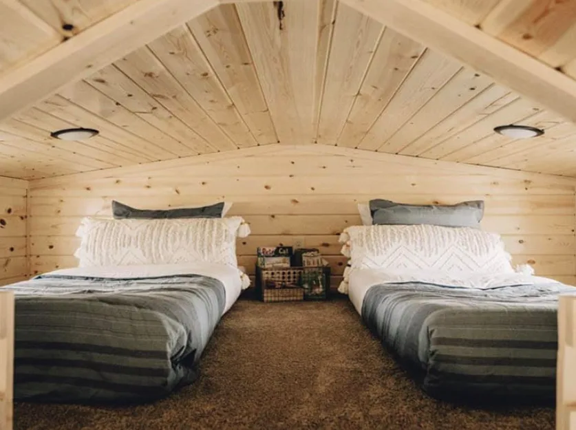 Two beds in a tiny home sleeping loft