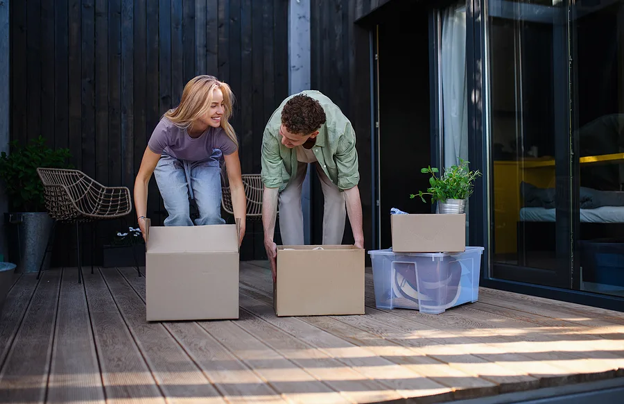 Couple carrying boxes during a move