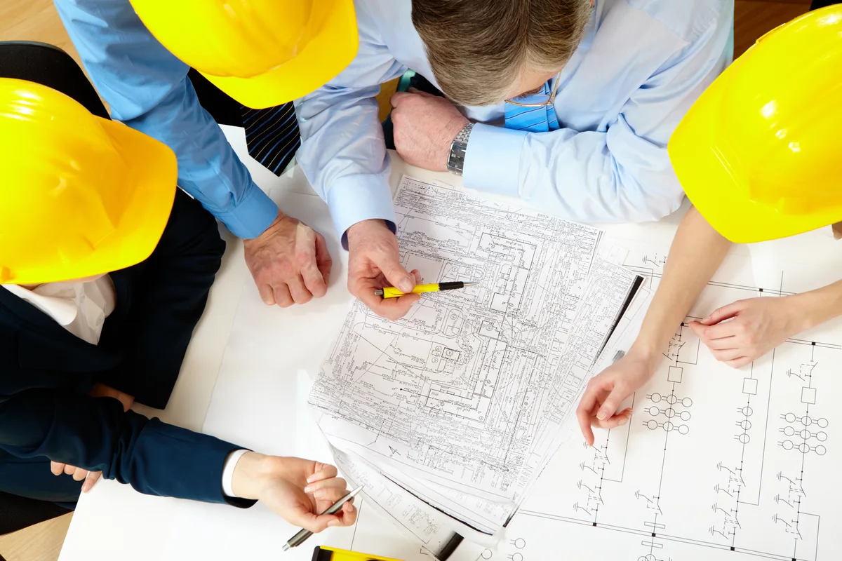 Construction professionals reviewing engineered plans