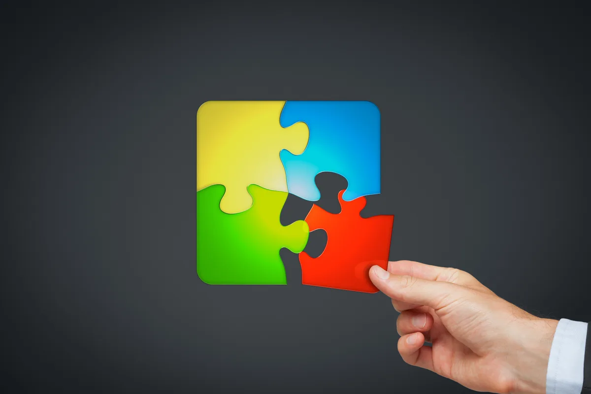 Hand completing a colorful puzzle
