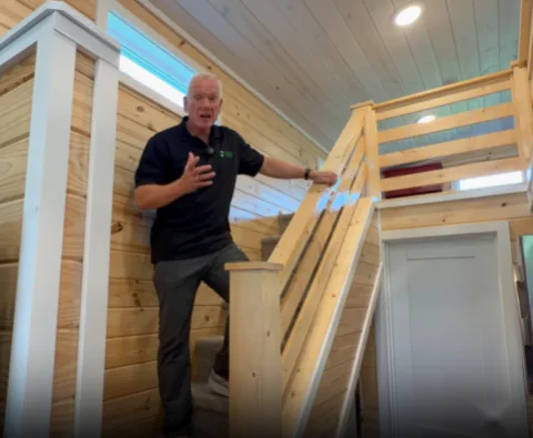 Porter inside a tiny home beside the loft access