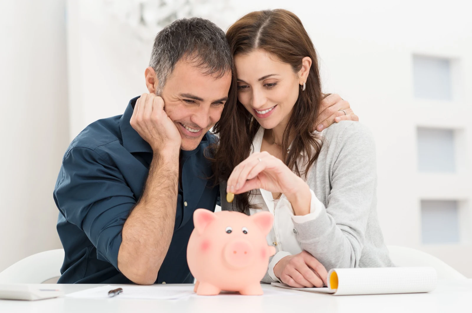 Couple saving money in a piggy bank