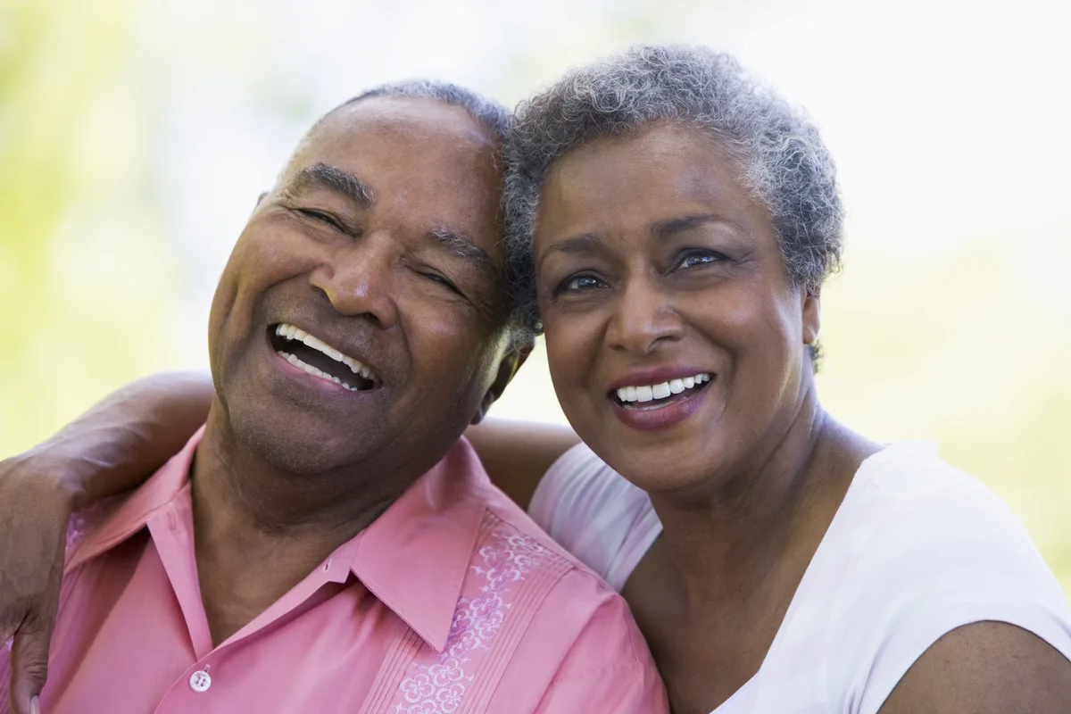 Older couple smiling together outdoors