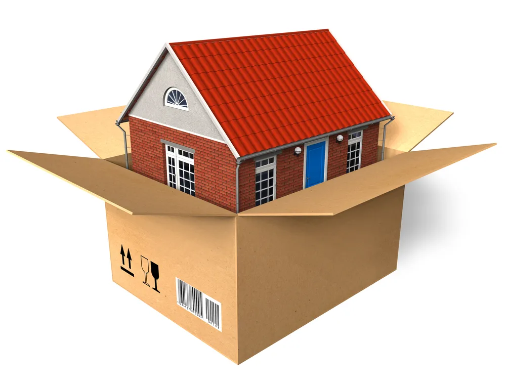 A model house inside a cardboard shipping box