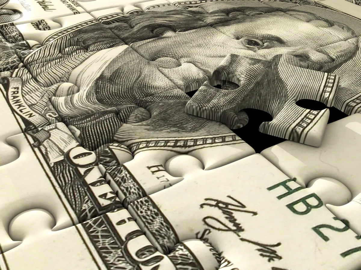 US currency arranged as puzzle pieces