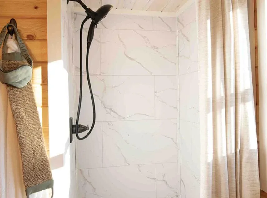 A walk-in shower in a tiny home bathroom
