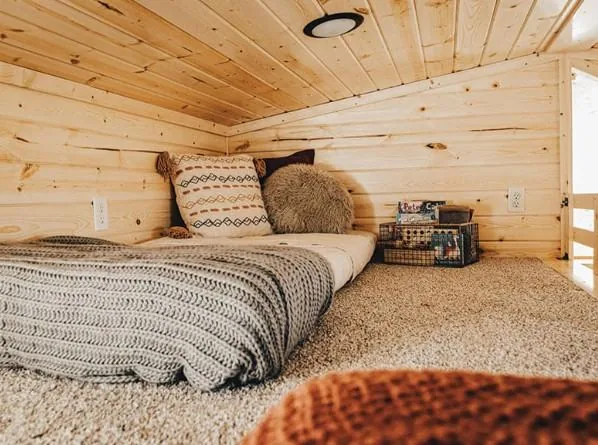 An Outpost bedroom with wood walls
