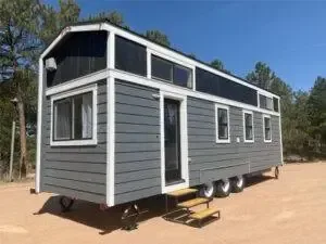 A park model tiny home in a dry desert setting typical of Nevada