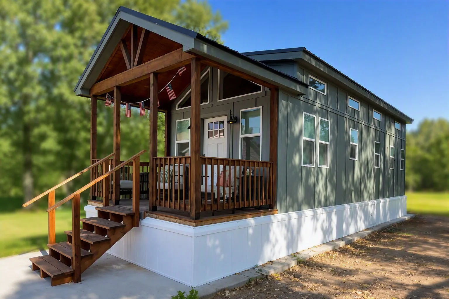 A Snake River Tiny Home with a covered porch and green board-and-batten siding