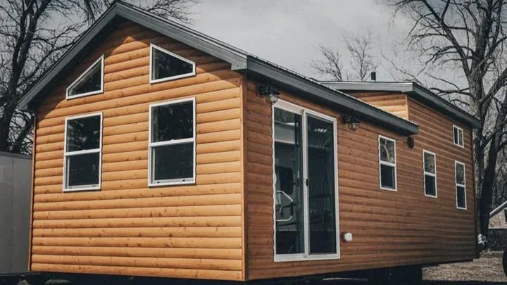 A Snake River Tiny Homes park model tiny home with a covered porch, set up in Idaho
