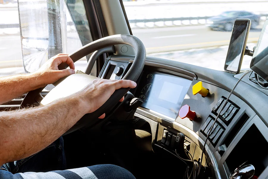 An experienced carrier behind the wheel of a transport truck