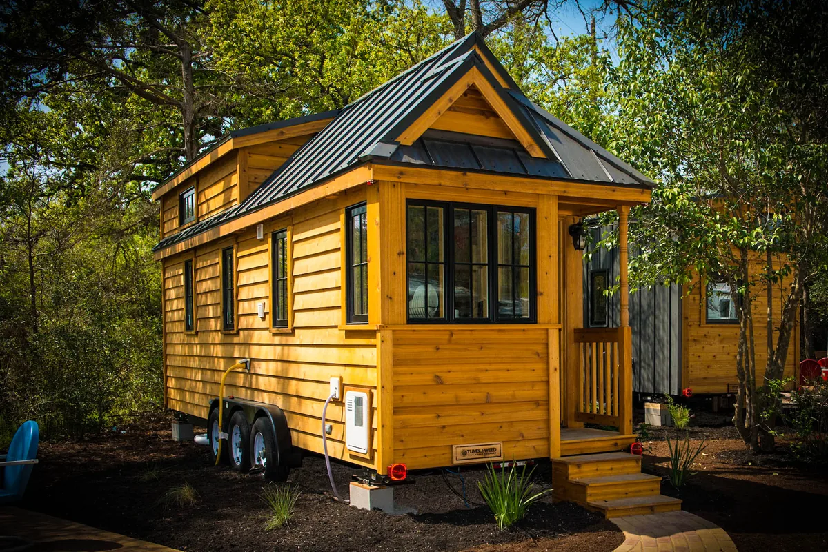The Tumbleweed Cypress tiny home with gabled roof and half porch